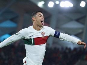Portugal's forward Cristiano Ronaldo celebrates after scoring his team's first goal during the UEFA Euro 2024 group J qualification football match between Luxembourg and Portugal at the Stade de Luxembourg, in Luxembourg, on March 26, 2023.