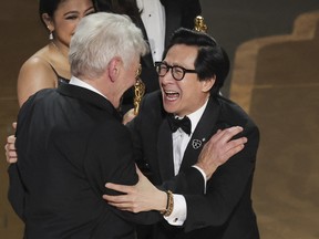 Ke Huy Quan receives the Oscar for Best Picture from Harrison Ford after "Everything Everywhere All at Once" won during the Oscars show at the 95th Academy Awards in Hollywood, Los Angeles March 12, 2023.