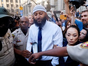 Adnan Syed, whose case was chronicled in the hit podcast Serial, departs the courthouse with his attorney Erica Suter, after a judge overturned Syed's 2000 murder conviction and ordered a new trial during a hearing at the Baltimore City Circuit Courthouse in Baltimore, Md., Sept. 19, 2022.