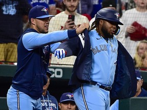 Toronto Blue Jays first baseman Vladimir Guerrero Jr. receives the blue jacket from pitcher Jose Berrios after hitting a solo home run against the St. Louis Cardinals during the sixth inning at Busch Stadium. (Jeff Curry-USA TODAY Sports)