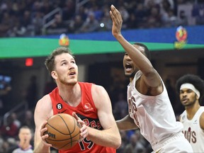 Feb 26, 2023; Cleveland, Ohio, USA; Toronto Raptors center Jakob Poeltl (19) looks to the basket beside Cleveland Cavaliers forward Evan Mobley (4) in the first quarter at Rocket Mortgage FieldHouse. Mandatory Credit: David Richard-USA TODAY Sports