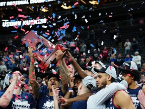 Mar 25, 2023; Las Vegas, NV, USA;  The Connecticut Huskies react after winning the NCAA tournament West Regional final against the Gonzaga Bulldogs at T-Mobile Arena in Los Vegas on March 25, 2023.