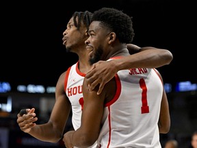 Houston Cougars guard Tramon Mark (12) hugs guard Jamal Shead (1) during the second half against the Memphis Tigers at Dickies Arena in Fort Worth, March 12, 2023.