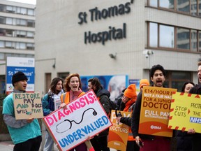 People attend a protest by junior doctors, amid a dispute with the government over pay, outside St Thomas' Hospital in London, Britain, March 13, 2023.
