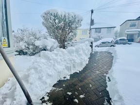 A house entrance is seen partially cleared from the snow in Sheffield, Britain, March 10, 2023, in this picture obtained from social media.