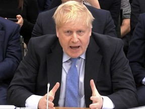 A video grab from footage broadcast by the U.K. Parliament's Parliamentary Recording Unit (PRU) shows former British Prime Minister Boris Johnson making his opening statement as he attends a Parliamentary Privileges Committee hearing, in central London on March 22, 2023.