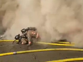 Buffalo firefighters get knocked down following an explosion while fighting a fire Wednesday, March 1, 2023 in this screengrab taken from video.
