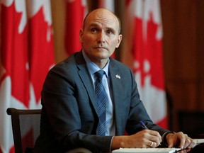 Canada's Minister of Health Jean-Yves Duclos listens during a news conference in Ottawa on Feb. 11, 2022.