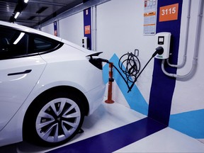 An electric vehicle is plugged into a charging station in Bilbao, Spain, Feb. 15, 2023.