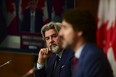 FILE PHOTO: Leader of the Government in the House of Commons Pablo Rodriguez (now Canada's Heritage Minister) looks towards Prime Minister Justin Trudeau as they take part in a press conference during the COVID pandemic in Ottawa on Friday, Oct. 16, 2020.