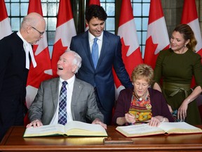 Governor General of Canada David Johnston, Mrs. Sharon Johnston take part in a book signing as Speaker of the House of Commons Geoff Regan, left, Prime Minister Justin Trudeau and Sophie Gregoire Trudeau look on in Ottawa on Thursday Sept. 28, 2017.