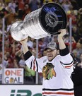 In this June 24, 2013, file photo, Chicago Blackhawks Daniel Carcillo hoists the Stanley Cup after the Blackhawks beat the Boston Bruins 3-2 in Game 6 of the NHL hockey Stanley Cup Finals in Boston.