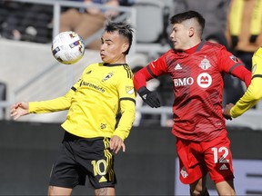 Columbus Crew midfielder Lucas ZelarayÃ¡n, left, shields the ball as Toronto FC defender Kadin Chung defends during the second half of an MLS soccer match on Saturday, March 12, 2022, in Columbus, Ohio.