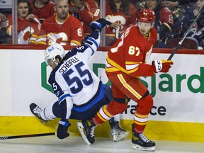 Winnipeg Jets forward Mark Scheifele gets rubbed out along the boards by Calgary Flames' Radim Zohorna -- now with the Leafs.