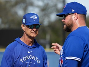 Blue Jays bench coach Don Mattingly, left, talks with manager John Schneider during baseball spring training in Dunedin, Fla., on Tuesday, Feb. 21, 2023.