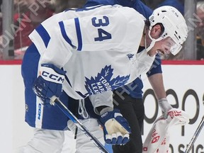 Maple Leafs' Auston Matthews limps off the ice after taking a blocked shot  off his knee during the first period against the  Canucks in Vancouver, on Saturday, March 4, 2023.