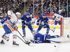 Toronto Maple Leafs goaltender Matt Murray sprawls to stop a Connor McDavid shot during third period NHL hockey action against the Edmonton Oilers in Toronto.