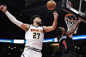 Denver Nuggets' Jamal Murray knocks the ball away from Raptors' Will Barton during the first half in Toronto on Tuesday, March 14, 2023.