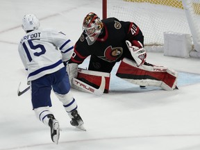 Toronto Maple Leafs centre Alexander Kerfoot slips the puck under Ottawa Senators goaltender Mads Sogaard for the ninth-round shootout winner in Ottawa, Saturday, March 18, 2023.