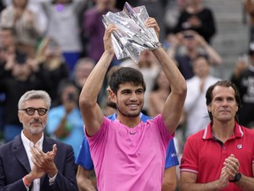 Carlos Alcaraz, of Spain, holds the winner's trophy after defeating Daniil Medvedev, of Russia, in the men's singles final at the BNP Paribas Open tennis tournament Sunday, March 19, 2023, in Indian Wells, Calif.