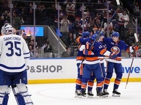 Maple Leafs goaltender Ilya Samsonov looks away as the New York Islanders celebrate a goal by Hudson Fasching during the second period on Tuesday, March 21, 2023, in Elmont, N.Y.