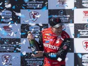 Team Penske driver Will Power, of Australia, celebrates after winning third place in the IndyCar season finale auto race at Laguna Seca Raceway on Sept. 11, 2022, Monterey, Calif.