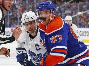 Edmonton Oilers forward Connor McDavid, right, and Toronto Maple Leafs forward John Tavares follow a loose puck during the second period at Rogers Place in Edmonton, March 1, 2023.