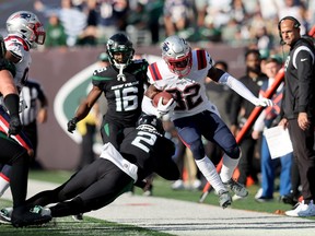 Oct 30, 2022; East Rutherford, New Jersey, USA; New England Patriots safety Devin McCourty (32) is forced out of bounds by New York Jets quarterback Zach Wilson (2) after an interception during the fourth quarter at MetLife Stadium.