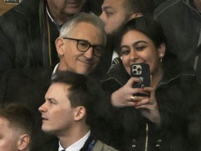 Former player and TV presenter Gary Lineker takes a selfie with a fan after the match between Leicester City and Chelsea at King Power Stadium, Leicester, Britain, on March 11, 2023.