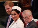 (L-R) Britain's Prince Harry, Duke of Sussex, Britain's Meghan, Duchess of Sussex and Britain's Prince Andrew, Duke of York, are seated as they attend the Commonwealth Day service at Westminster Abbey in London on March 11, 2019.