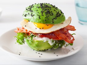 Avocado breakfast burger with bacon, egg, tomato