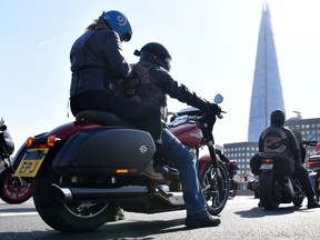 Members of the Hells Angels motorcycle club ride their bikes across London Bridge on March 26, 2022. (Photo by JUSTIN TALLIS/AFP via Getty Images)