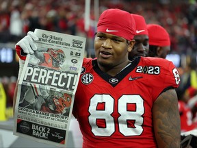 Jalen Carter of the Georgia Bulldogs celebrates with a newspaper reading "Perfect!" after defeating the TCU Horned Frogs in the College Football Playoff National Championship game at SoFi Stadium on January 09, 2023 in Inglewood, California.