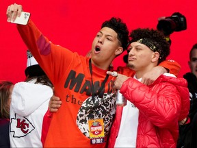 Jackson Mahomes, left, and Patrick Mahomes of the Kansas City Chiefs celebrate on stage during the Kansas City Chiefs Super Bowl LVII victory parade on February 15, 2023 in Kansas City, Missouri.