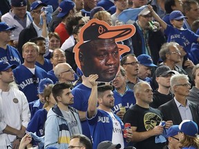 A Toronto Blue Jays fan holds up a cardboard cutout of the crying Michael Jordan meme before the start of the game against the Baltimore Orioles in the American League Wild Card game at Rogers Centre on October 4, 2016 in Toronto, Canada. (Photo by Tom Szczerbowski/Getty Images)