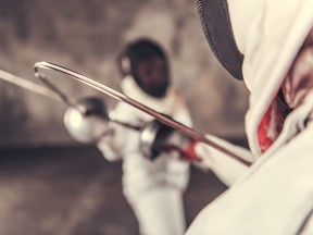 Two women fencing