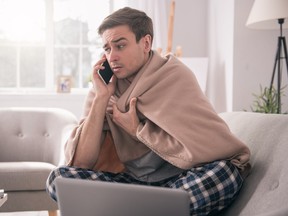 Sick man talking on the phone to his employer.