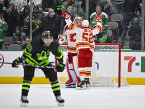 Jan 14, 2023; Dallas, Texas, USA; Calgary Flames defenseman MacKenzie Weegar (52) and goaltender Dan Vladar (80) celebrate the victory over the Dallas Stars in the game at the American Airlines Center.