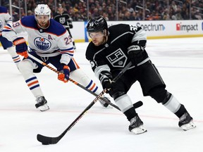 Jan 9, 2023; Los Angeles, California, USA; Los Angeles Kings right wing Viktor Arvidsson (33) controls the puck in front of Edmonton Oilers center Leon Draisaitl (29) during the second period against the Edmonton Oilers at Crypto.com Arena.
