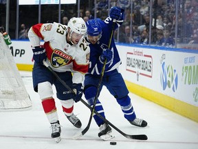 Mar 27, 2022; Toronto, Ontario, CAN; Florida Panthers forward Carter Verhaeghe (23) and Toronto Maple Leafs defenseman Timothy Liljegren (37) battle for the puck  during the second period at Scotiabank Arena.