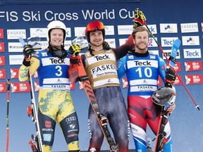 Canada’s Reece Howden (centre) celebrates his first-place finish in the FIS Ski Cross World Cup on the podium alongside second-place finisher Florian Wilmsmann, (left) of Germany, and third place finisher Youri Duplessis Kergomard, of France, in The Blue Mountains, Ont. Handout