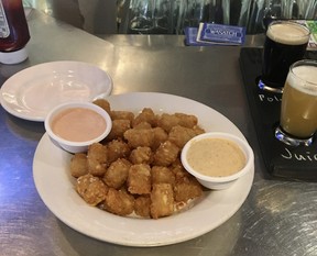 Tater tots and a flight of beer — including Polygamy Porter, of course, at Wasatch Brew Pub. CYNTHIA MCLEOD/TORONTO SUN