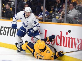 Nashville Predators centre Matt Duchene (95) hits the boards as he goes for a puck against Toronto Maple Leafs captain John Tavares at Bridgestone Arena on Sunday. Tavares had two goals and an assist in the game.