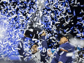 Toronto Argonauts wide receiver Brandon Banks (16) and Toronto Argonauts running back Andrew Harris (33) celebrate after defeating the Winnipeg Blue Bombers  during the 109th Grey Cup at Mosaic Stadium on Sunday, November 20, 2022 in Regina.