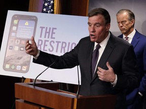 Senate Select Committee on Intelligence Chairman Mark Warner (D-VA), left, is joined by Senate Minority Whip John Thune (R-SD), right, to introduce the Restrict Act at the U.S. Capitol in Washington, D.C., March 7, 2023.