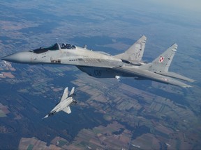 This file photo taken on Oct. 12, 2022 shows two MiG 29 fighter jets taking part in the NATO Air Shielding exercise near the air base in Lask, central Poland.