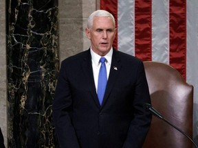 U.S. Vice President Mike Pence reads the final certification of Electoral College votes cast in the 2020 presidential election during a joint session of Congress after working through the night, at the Capitol in Washington, D.C., Jan. 7, 2021.