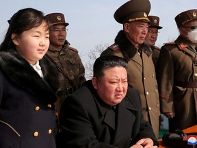 North Korean leader Kim Jong Un and his daughter Kim Ju Ae watch a missile drill at an undisclosed location in this image released by North Korea's Central News Agency (KCNA) on March 20, 2023.