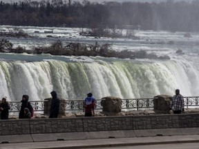 Visitors take in the view of Niagara Falls on the Canadian side, March 24, 2023.
