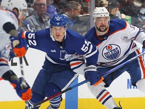 Devin Shore of the Edmonton Oilers skates against Noel Acciari of the Toronto Maple Leafs during an NHL game at Scotiabank Arena on March 11, 2023 in Toronto.